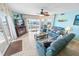 Bright living room with coastal decor, tile flooring, and access to a private balcony at 2967 S Atlantic Ave # 508, Daytona Beach, FL 32118