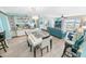 Open living room with dining area, bar, balcony access and tile flooring at 2967 S Atlantic Ave # 508, Daytona Beach, FL 32118
