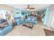 Open living area with tile floors, blue sofas, coastal decor, and ocean views at 2967 S Atlantic Ave # 508, Daytona Beach, FL 32118