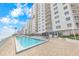 Exterior view of pool area with building in the background, perfect for relaxation at 2967 S Atlantic Ave # 508, Daytona Beach, FL 32118