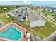 Aerial view featuring a shared community pool, parking, and residential buildings at 30 Inlet Harbor Rd # 606, Ponce Inlet, FL 32127