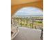 View of the ocean from balcony with rocking chairs and metal railing at 30 Inlet Harbor Rd # 606, Ponce Inlet, FL 32127
