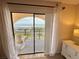 View of the ocean from balcony with rocking chair through sliding glass door at 30 Inlet Harbor Rd # 606, Ponce Inlet, FL 32127