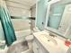 Beautifully renovated bathroom with shower/tub combo with grey tiled walls at 30 Inlet Harbor Rd # 606, Ponce Inlet, FL 32127