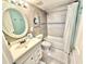 Updated bathroom with a tub and shower combo and beachy shiplap wall at 30 Inlet Harbor Rd # 606, Ponce Inlet, FL 32127