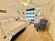 Coastal bedroom with two beds, ceiling fan, and a starfish accent chair at 30 Inlet Harbor Rd # 606, Ponce Inlet, FL 32127