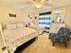 Nautical-themed bedroom with two beds, ceiling fan, and wicker furniture at 30 Inlet Harbor Rd # 606, Ponce Inlet, FL 32127