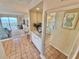 Inviting entryway with built-in storage, a large mirror and light tile flooring leading to the open-concept living area at 30 Inlet Harbor Rd # 606, Ponce Inlet, FL 32127