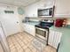 Kitchen with stainless appliances and white cabinets at 30 Inlet Harbor Rd # 606, Ponce Inlet, FL 32127