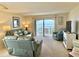 Bright, comfortable living room with plush leather seating and a large sliding door showcasing a beautiful ocean view at 30 Inlet Harbor Rd # 606, Ponce Inlet, FL 32127