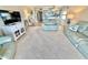 Spacious living room with television and decor, bright windows, and a view into other parts of the house at 30 Inlet Harbor Rd # 606, Ponce Inlet, FL 32127
