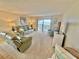 Spacious living room with leather furniture, bright windows, and access to a balcony with a stunning ocean view at 30 Inlet Harbor Rd # 606, Ponce Inlet, FL 32127