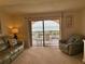 Inviting living room with plush seating, decor, and access to a balcony with ocean views at 30 Inlet Harbor Rd # 606, Ponce Inlet, FL 32127