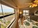 Living room view featuring an expansive beach scene, with comfortable seating and access to a private balcony at 30 Inlet Harbor Rd # 606, Ponce Inlet, FL 32127