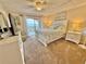 Comfortable main bedroom with a queen bed, dresser, ceiling fan and ocean view balcony at 30 Inlet Harbor Rd # 606, Ponce Inlet, FL 32127