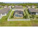 Aerial view of fenced backyard with pool and covered patio in lush green neighborhood at 3116 Crab Trap Dr, New Smyrna Beach, FL 32168