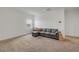Comfortable bonus room features neutral carpet and cozy sectional couch at 3116 Crab Trap Dr, New Smyrna Beach, FL 32168