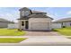 Two-story home with a brick driveway and attached two-car garage at 3116 Crab Trap Dr, New Smyrna Beach, FL 32168