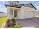 Exterior of two-story home with a two-car garage and stone landscaping at 3116 Crab Trap Dr, New Smyrna Beach, FL 32168