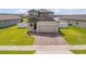 Charming two-story home with a well-maintained lawn and brick driveway at 3116 Crab Trap Dr, New Smyrna Beach, FL 32168
