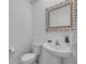 Cozy half-bath features decorative mirror and pedestal sink at 3116 Crab Trap Dr, New Smyrna Beach, FL 32168