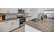 Well-equipped kitchen with white cabinets, stainless steel appliances, and an island at 3116 Crab Trap Dr, New Smyrna Beach, FL 32168