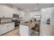 Bright kitchen featuring a center island, granite counters, and stainless appliances at 3116 Crab Trap Dr, New Smyrna Beach, FL 32168