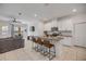 Open-concept kitchen with bar seating, white cabinetry, and granite countertops at 3116 Crab Trap Dr, New Smyrna Beach, FL 32168