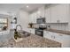 Modern kitchen with white cabinets, granite countertops, and stainless steel appliances at 3116 Crab Trap Dr, New Smyrna Beach, FL 32168