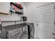 Laundry room featuring a modern washer and dryer, shelving, and a white door at 3116 Crab Trap Dr, New Smyrna Beach, FL 32168