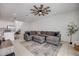Comfortable living room featuring a sectional sofa, ceiling fan, and neutral décor at 3116 Crab Trap Dr, New Smyrna Beach, FL 32168