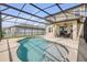 Screened patio with pool, outdoor seating, and an attached covered seating area at 3116 Crab Trap Dr, New Smyrna Beach, FL 32168