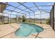 Screened pool in a backyard with beautiful landscaping and lake view at 3116 Crab Trap Dr, New Smyrna Beach, FL 32168