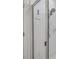 Modern shower with a glass door, multiple shower heads, and sleek, all-white tiled walls at 3116 Crab Trap Dr, New Smyrna Beach, FL 32168