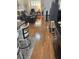 Hardwood floors leading into the living room with a large window letting in natural light at 3552 Casalta Cir, New Smyrna Beach, FL 32168