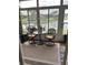 Enclosed patio area with decorative table and chairs overlooking a peaceful pond and lush landscaping at 3552 Casalta Cir, New Smyrna Beach, FL 32168