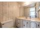 Vintage bathroom featuring a white vanity with cabinets and a large mirror at 3800 Saxon Dr # 180, New Smyrna Beach, FL 32169