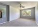 A neutral bedroom with natural light, carpeting, and plenty of open space at 3800 Saxon Dr # 180, New Smyrna Beach, FL 32169