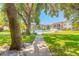 Beautiful community pool surrounded by lush landscaping and seating areas at 3800 Saxon Dr # 180, New Smyrna Beach, FL 32169