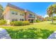 Well-maintained condo building with a lush green lawn and mature landscaping at 3800 Saxon Dr # 180, New Smyrna Beach, FL 32169