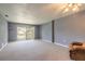 Bright and airy living room with a sliding glass door to balcony at 3800 Saxon Dr # 180, New Smyrna Beach, FL 32169