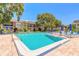 A pristine community pool with lounge chairs offering a relaxing outdoor space at 3800 Saxon Dr # 180, New Smyrna Beach, FL 32169
