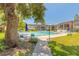 Beautiful community pool area with lounge chairs and well-maintained landscaping under clear skies at 3800 Saxon Dr # 180, New Smyrna Beach, FL 32169