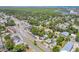 Scenic aerial view of a home nestled among lush trees near a bustling road and serene waterfront at 402 N Orange St, New Smyrna Beach, FL 32168