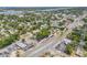 Panoramic aerial view showcasing a home with mature trees and proximity to local shops and amenities at 402 N Orange St, New Smyrna Beach, FL 32168