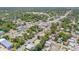 Sweeping aerial view showing a home situated in a leafy neighborhood, convenient to shops and roadways at 402 N Orange St, New Smyrna Beach, FL 32168