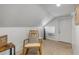Well-lit attic space with comfortable seating, perfect for relaxing or entertaining at 402 N Orange St, New Smyrna Beach, FL 32168