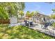 Spacious backyard featuring deck, grill, outdoor seating, shed, stairs, mature trees, and fence at 402 N Orange St, New Smyrna Beach, FL 32168