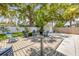 Backyard featuring outdoor seating, grill, mature trees, and white fence at 402 N Orange St, New Smyrna Beach, FL 32168