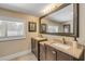 A bathroom with dual sinks and a large framed mirror at 402 N Orange St, New Smyrna Beach, FL 32168